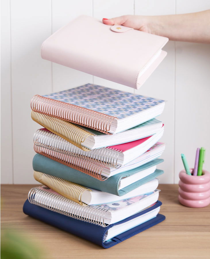 stack of colorful coiled lifeplanners and ring agendas.